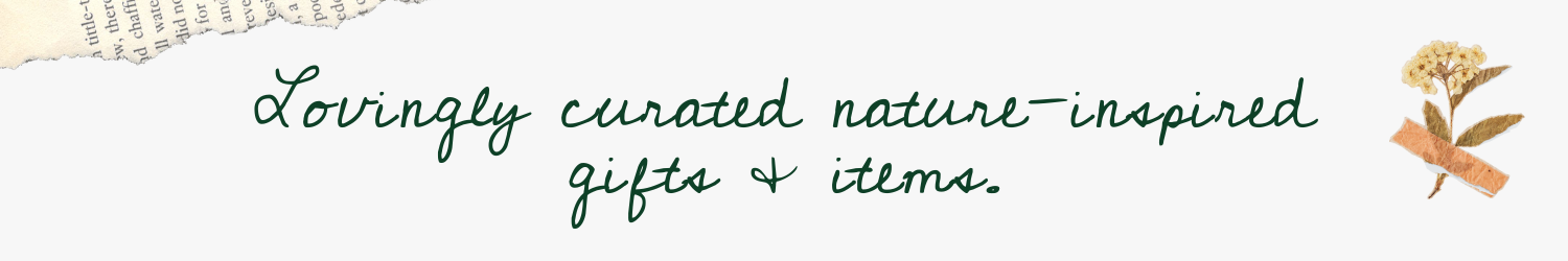 A header that features a strip of paper from a book and a dried flower taped to the page. There is text written in green cursive that reads "Lovingly curated nature-inspired gifts and items."